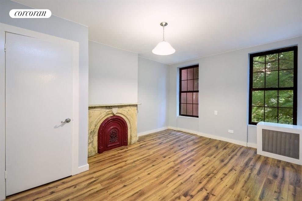 New York City Real Estate | View 379 Gates Avenue | Bedroom with original fireplace and garden views | View 12