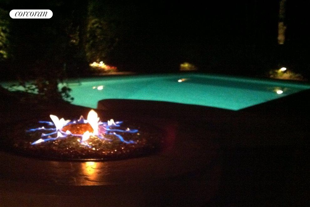 New York City Real Estate | View 36 Hampton Place | Pool at night with fire pit | View 7
