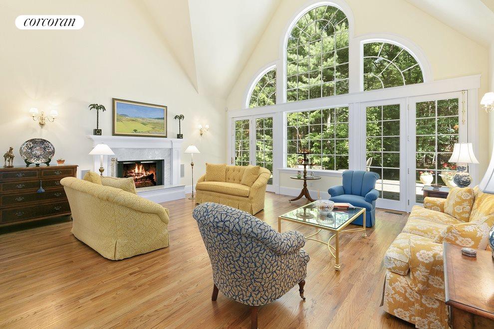New York City Real Estate | View  | Cathedral ceiling Living Room, woodburning fireplace and with entrances to back yard mahogany patio | View 3